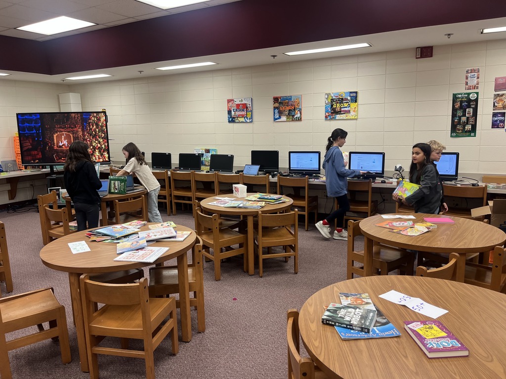Students looking up book levels and sorting books