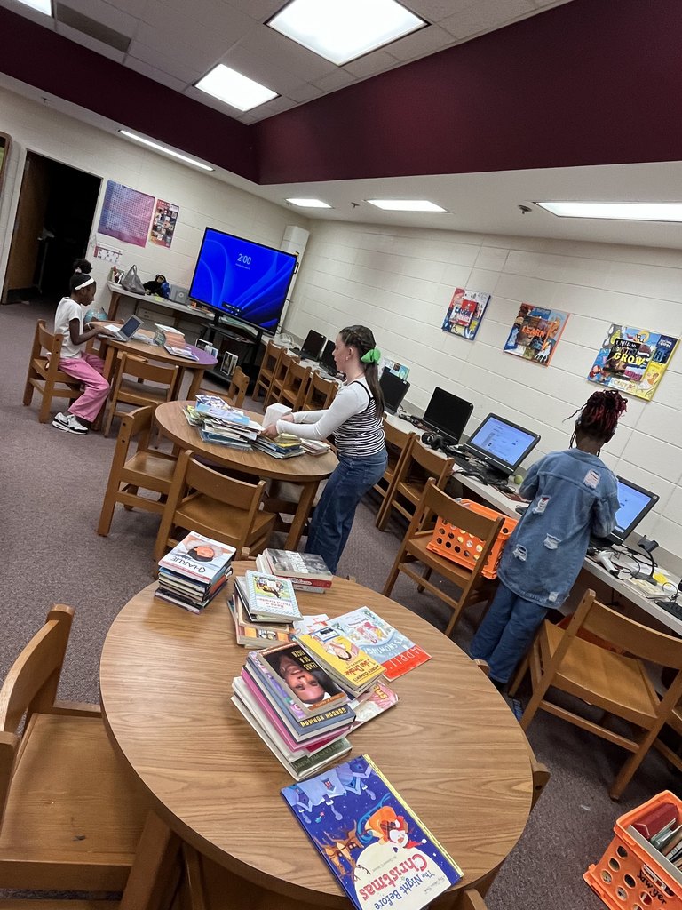 Students looking up book levels and sorting books