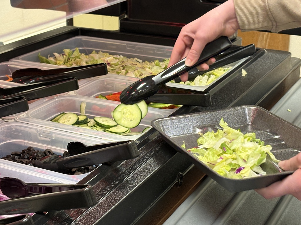 student grabbing cucumbers