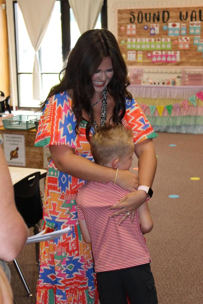 Kindergarten teacher meeting new student at Open House