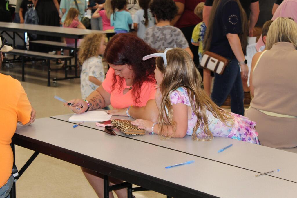 Parent filling out paperwork at Open House