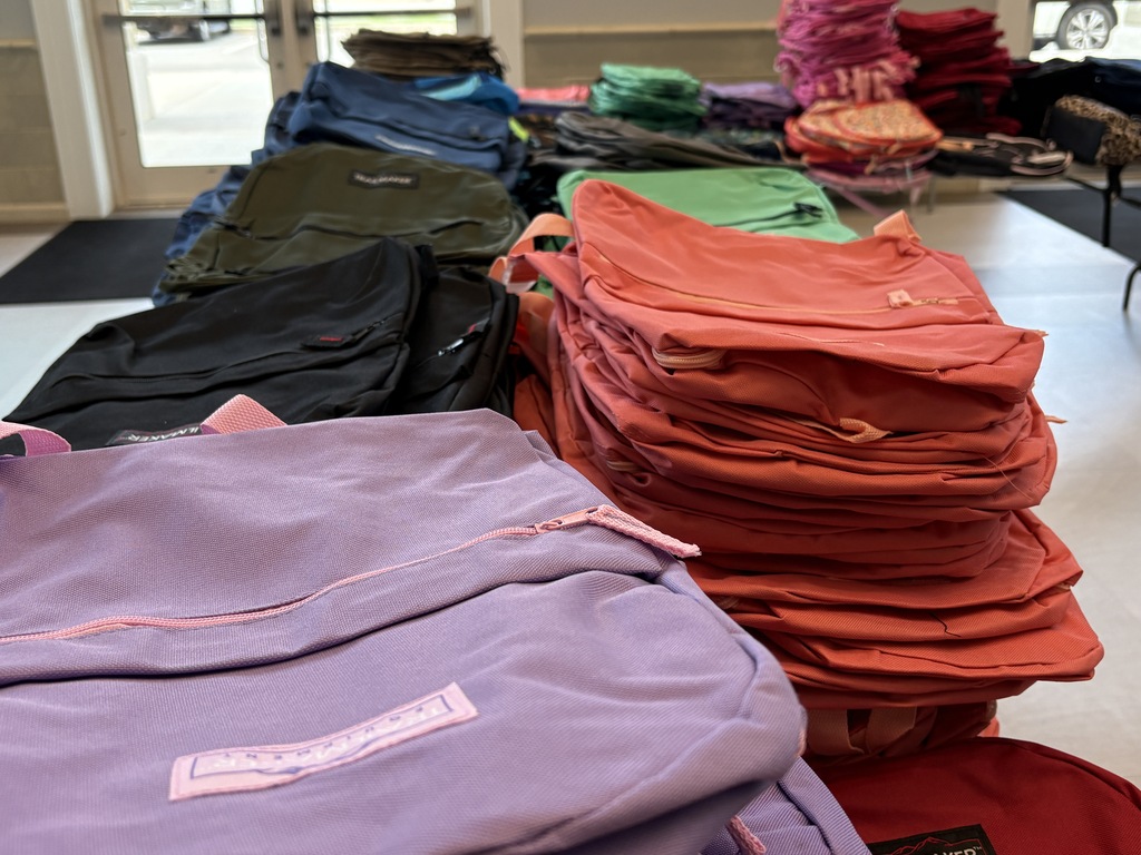 Stacks of backpacks sorted by color
