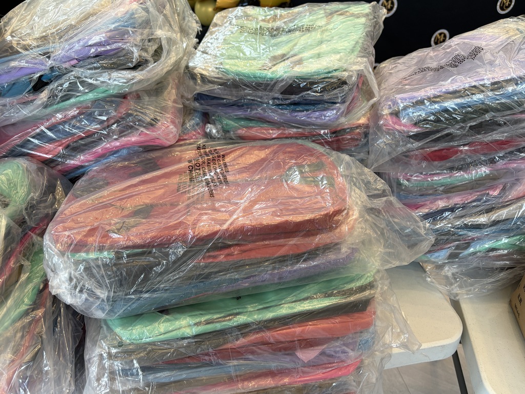 Stacks of backpacks still in plastic