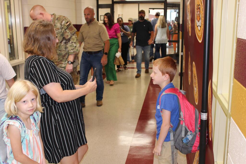 Parents walking students into the first day of school