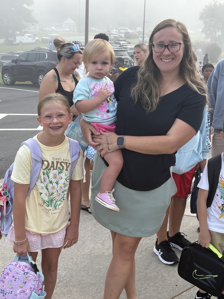 Parents walking students into the first day of school