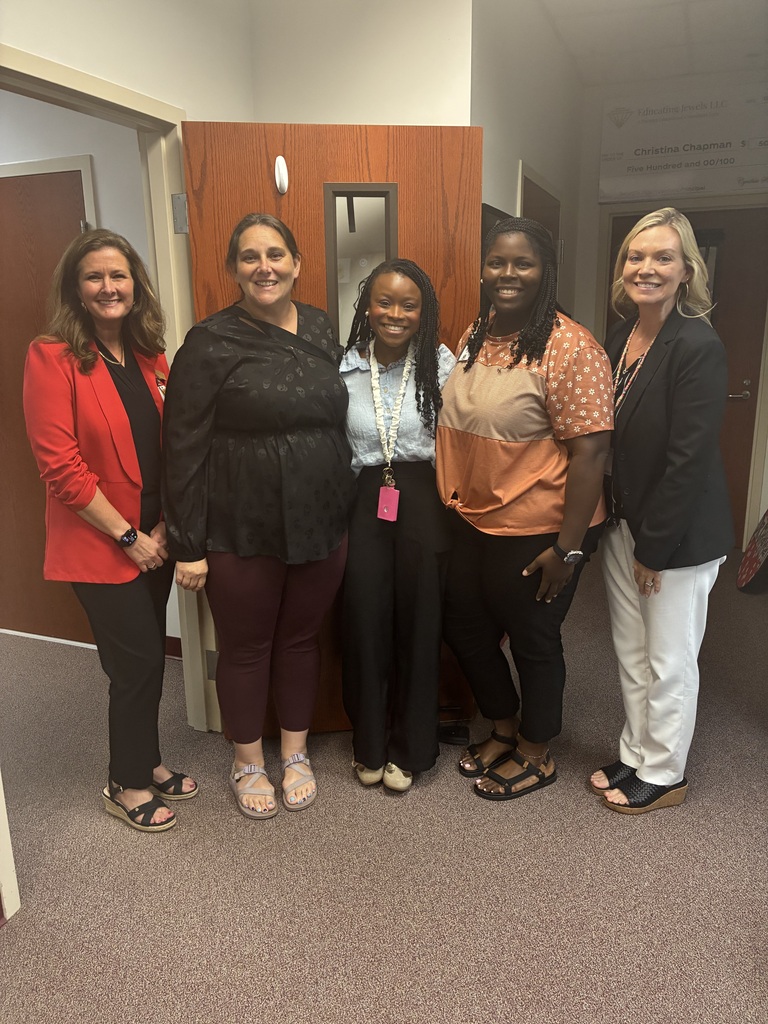 Group shot of paras with Asst. Supt. Laura Rackley and Principal Christina Chapman