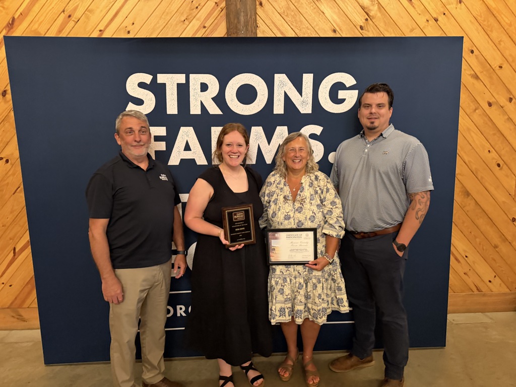 Picture of Mrs. Davis, Mrs. WIlliams and other Farm Bureau members recieving awards