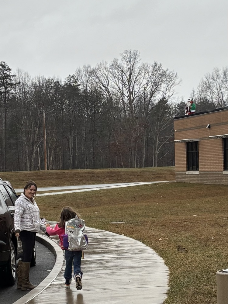 Santa Clayton the roof with his helper