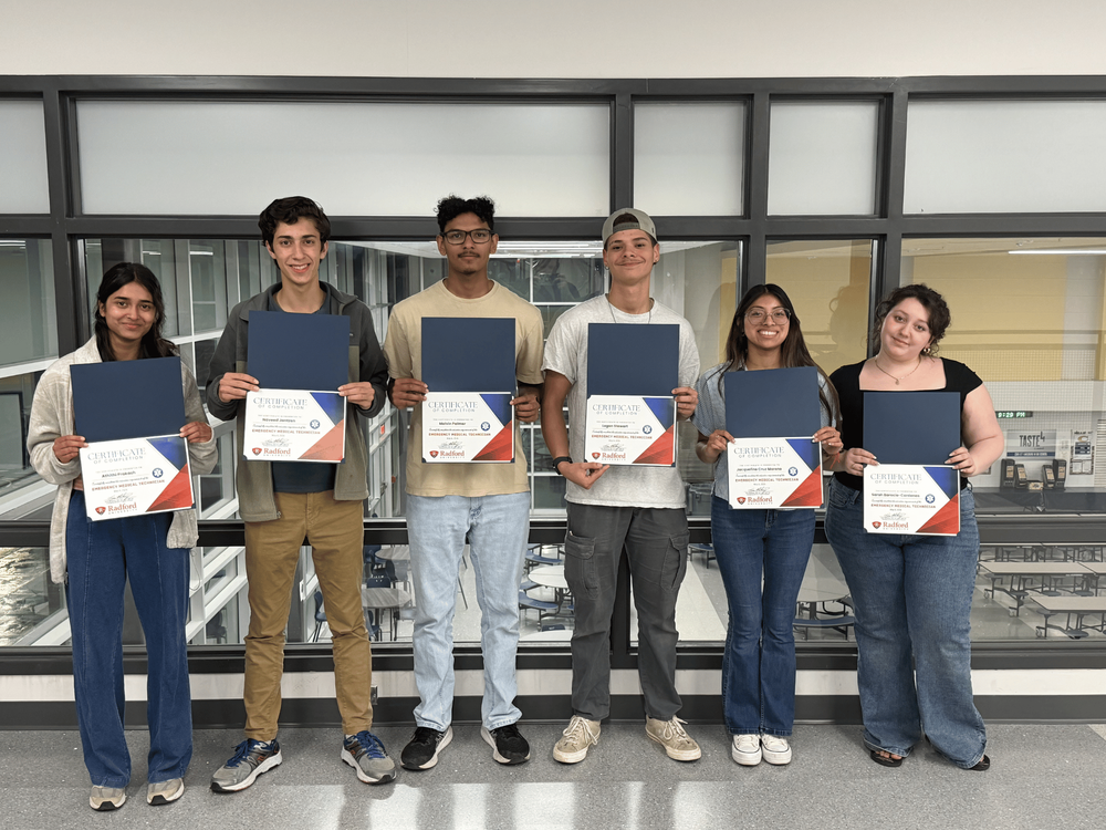 Six students standing with certificates