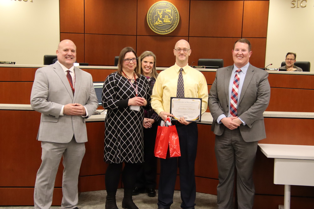 Mr. Marye standing with members of the board.