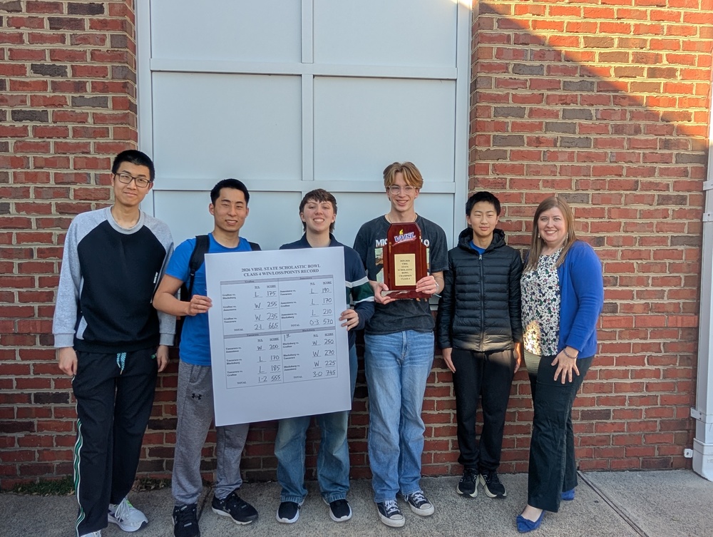six students standing with a state championship trophy