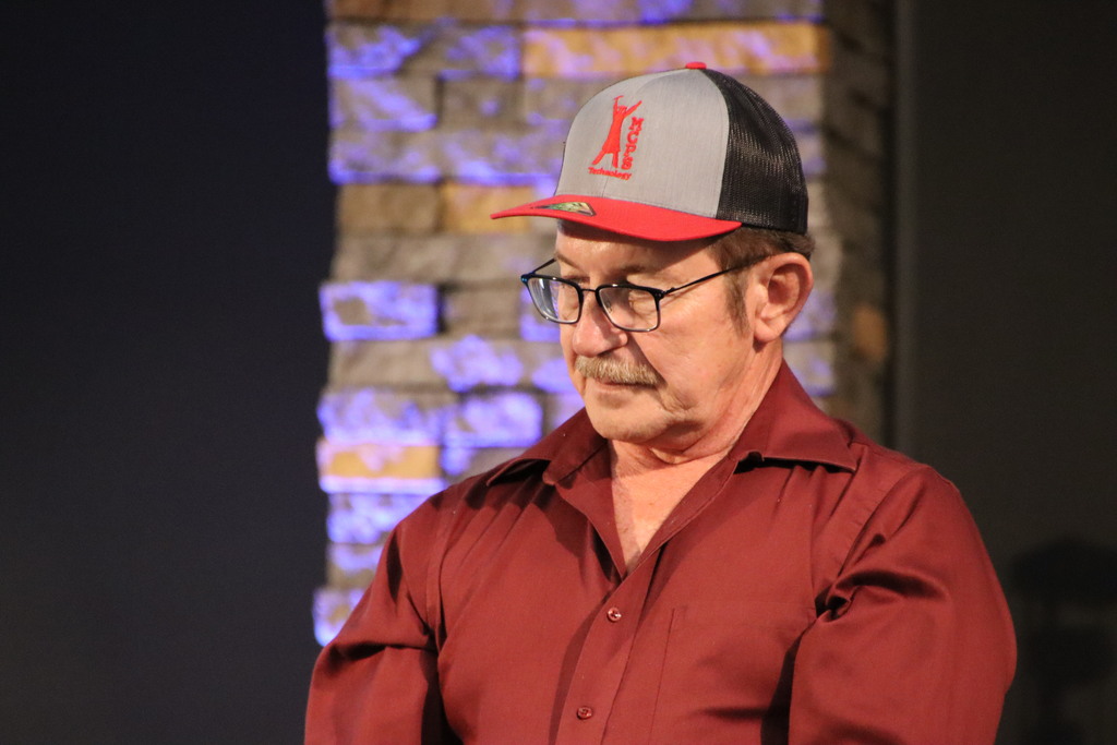 Man wearing hat at retirement dinner