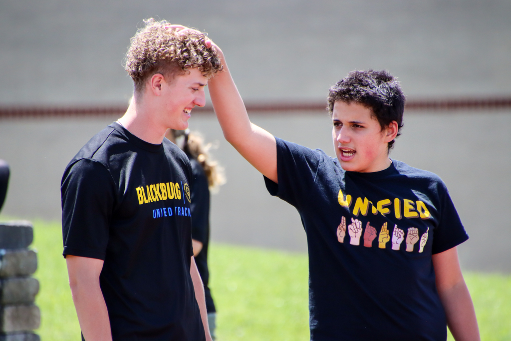 Two unified track athletes standing together