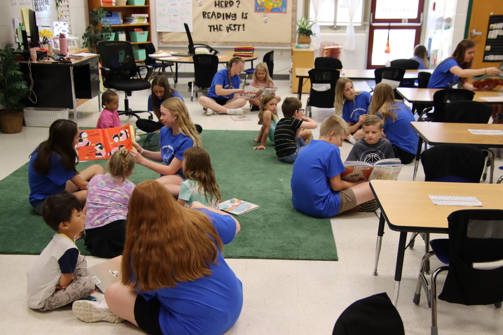 groups of students reading together on a classroom floor