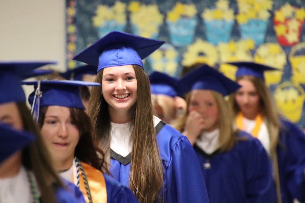 AHS student smiling and walking through the AES hallway