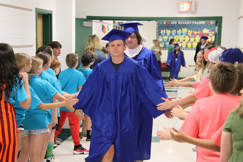 AHS student walking the halls at AES giving high fives to students