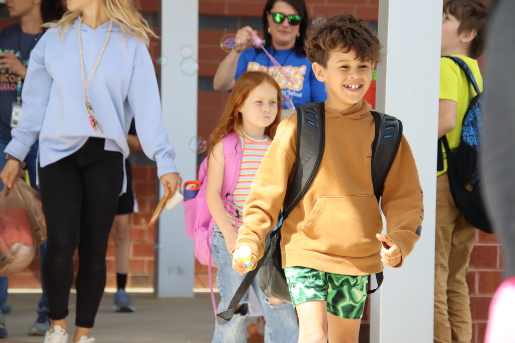 PFES students smiling while walking to the bus