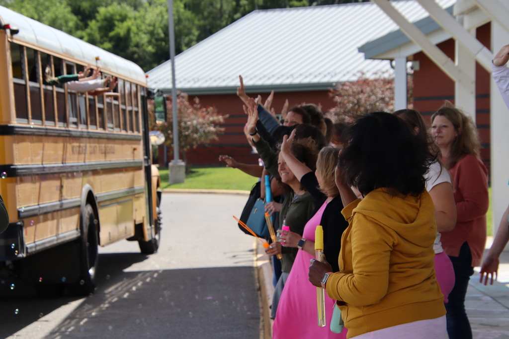PFES Staff waving to students on the bus
