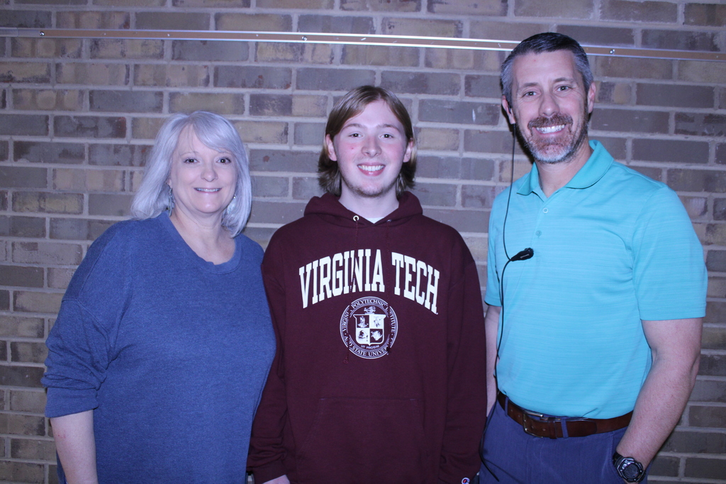 Cole Arnlold standing with two others