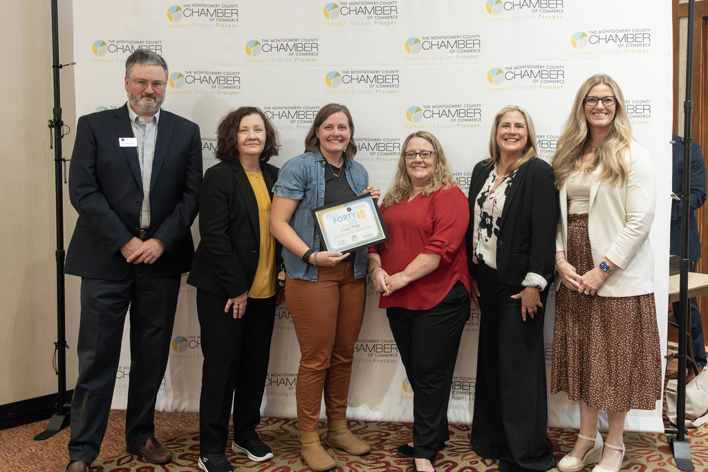 Emily Priddy standing with members of the Montgomery County Chamber of Commerce