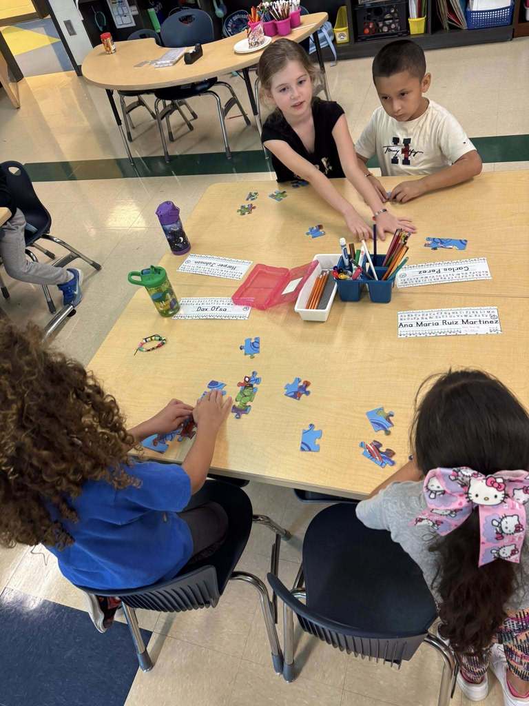 students piecing a puzzle