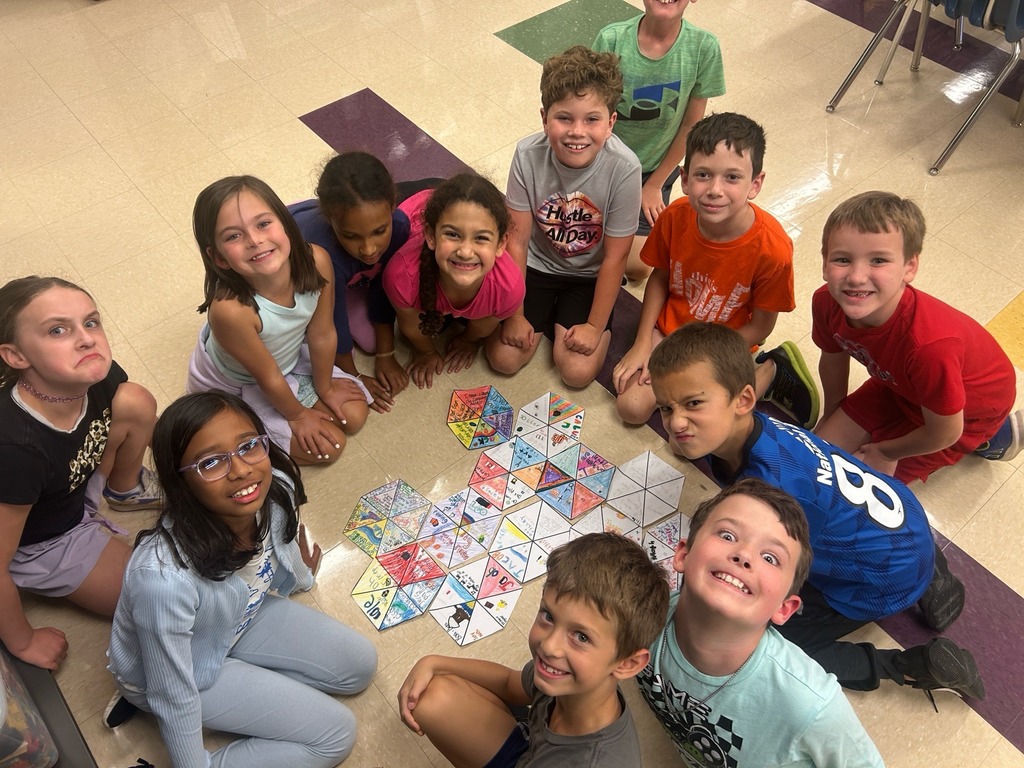 smiling students with their hexagon projects