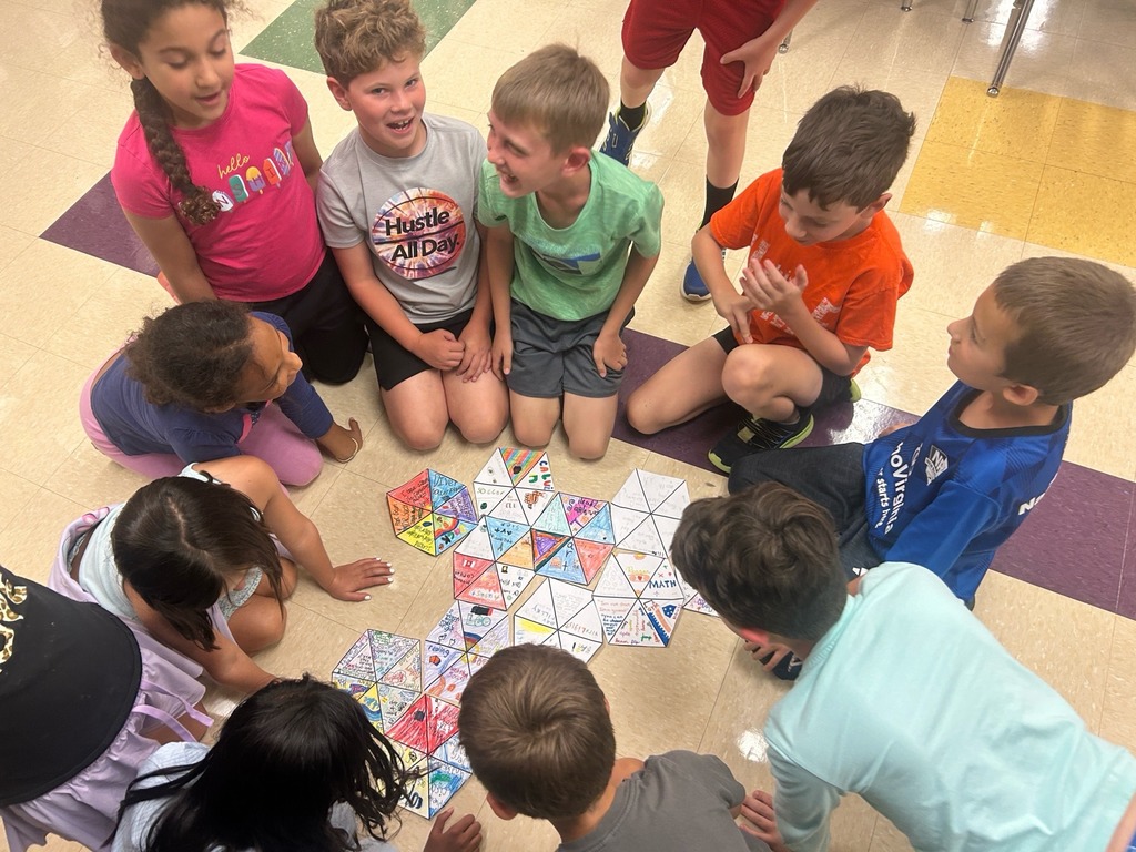 smiling students with their hexagon projects