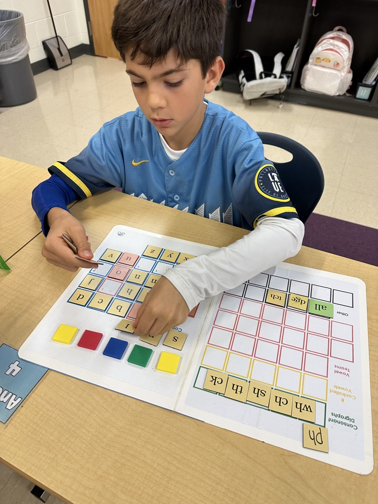student with reading manipulatives
