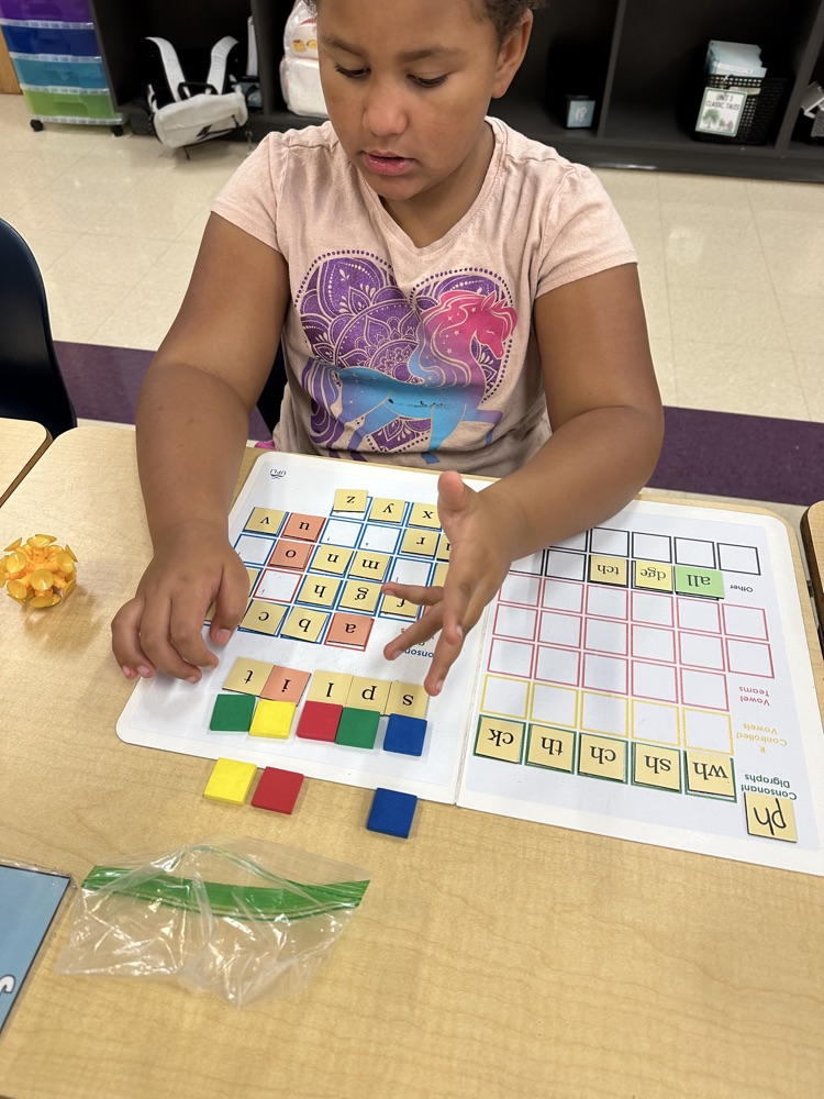 student with reading manipulatives
