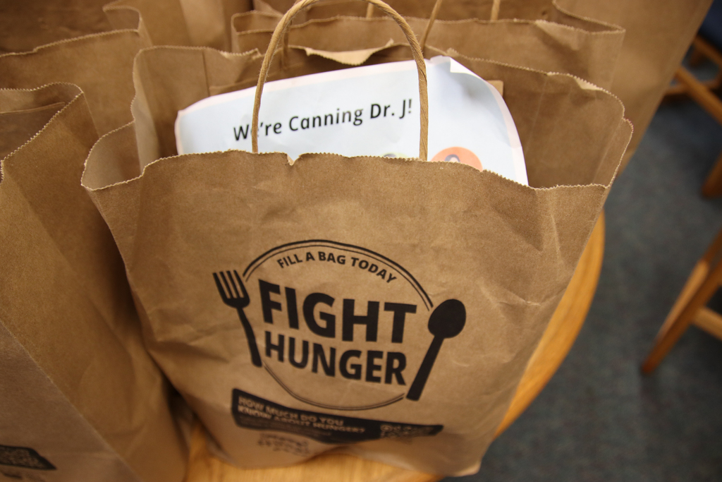 Bag that says fight hunger filled with cans.