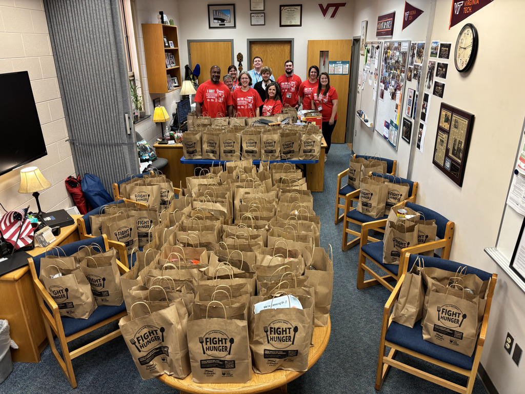 MCPS employees standing with bags filling Dr. J's office.