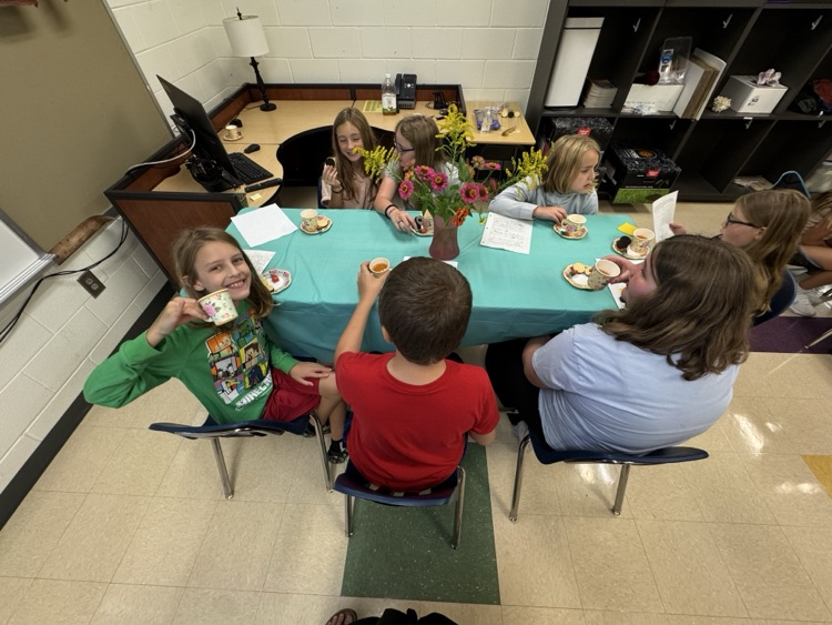 student smiling holding a teacup
