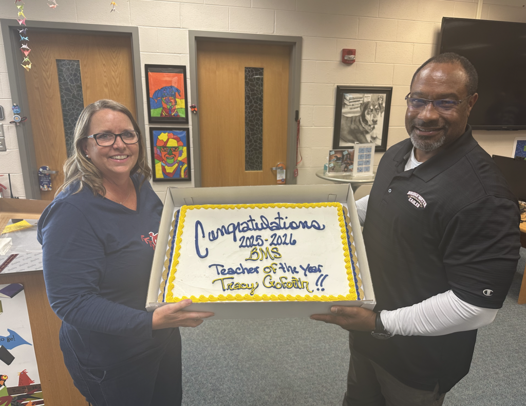 Mrs. Goforth and Dr. J holding a Teacher of the Year cake