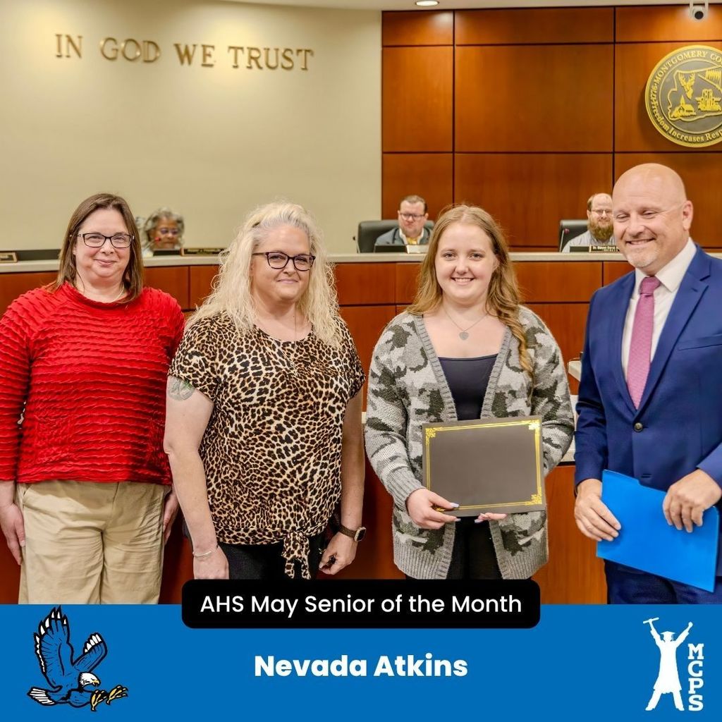 Nevada Atkins poses with a certificate for AHS May Senior of the Month, joined by three adults in a wood-paneled room.