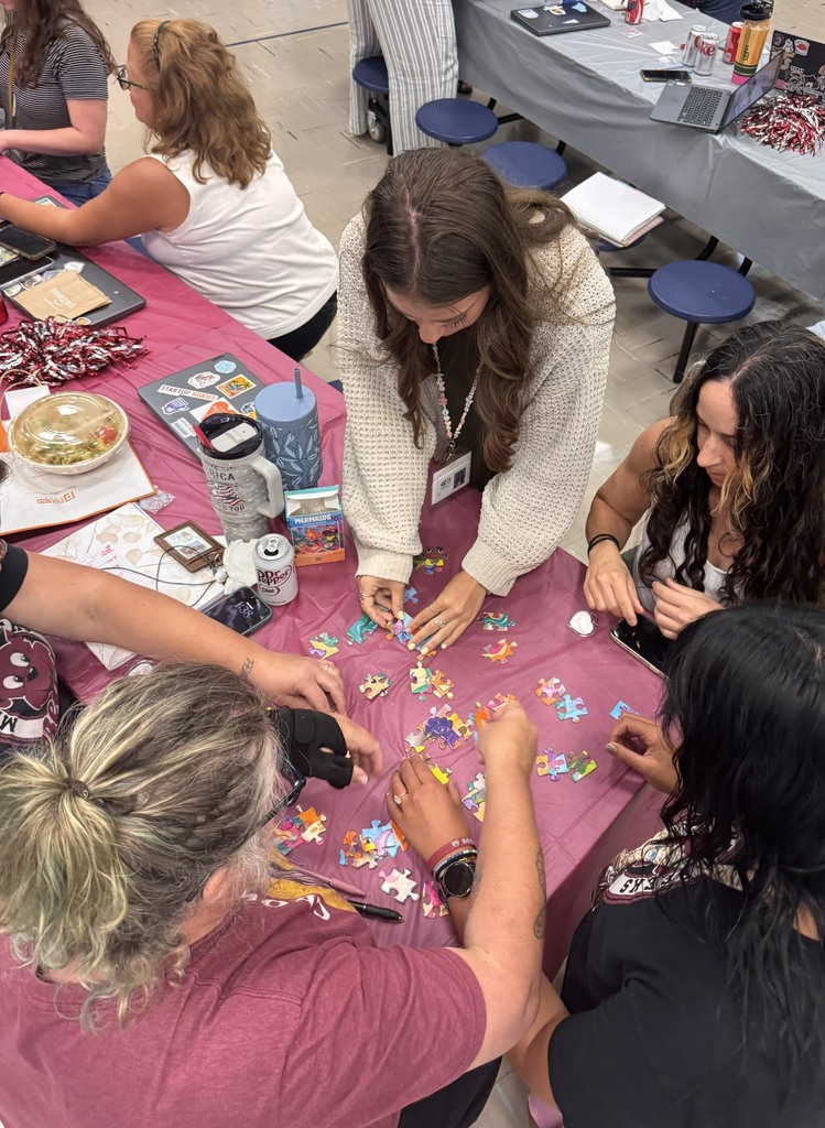 MBES staff members putting together a puzzle.