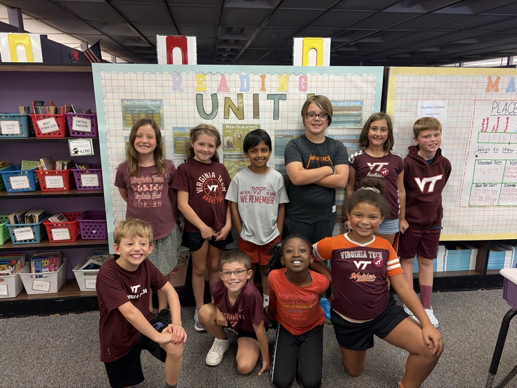 third grade students smile wearing Virginia Tech t-shirts 