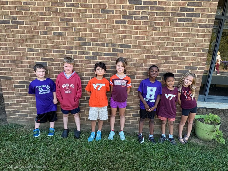 a group of first grade students pose outside wearing various college shirts 