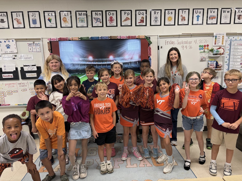 A group of third grade students wearing maroon and orange celebrating the Hokies for college colors day.