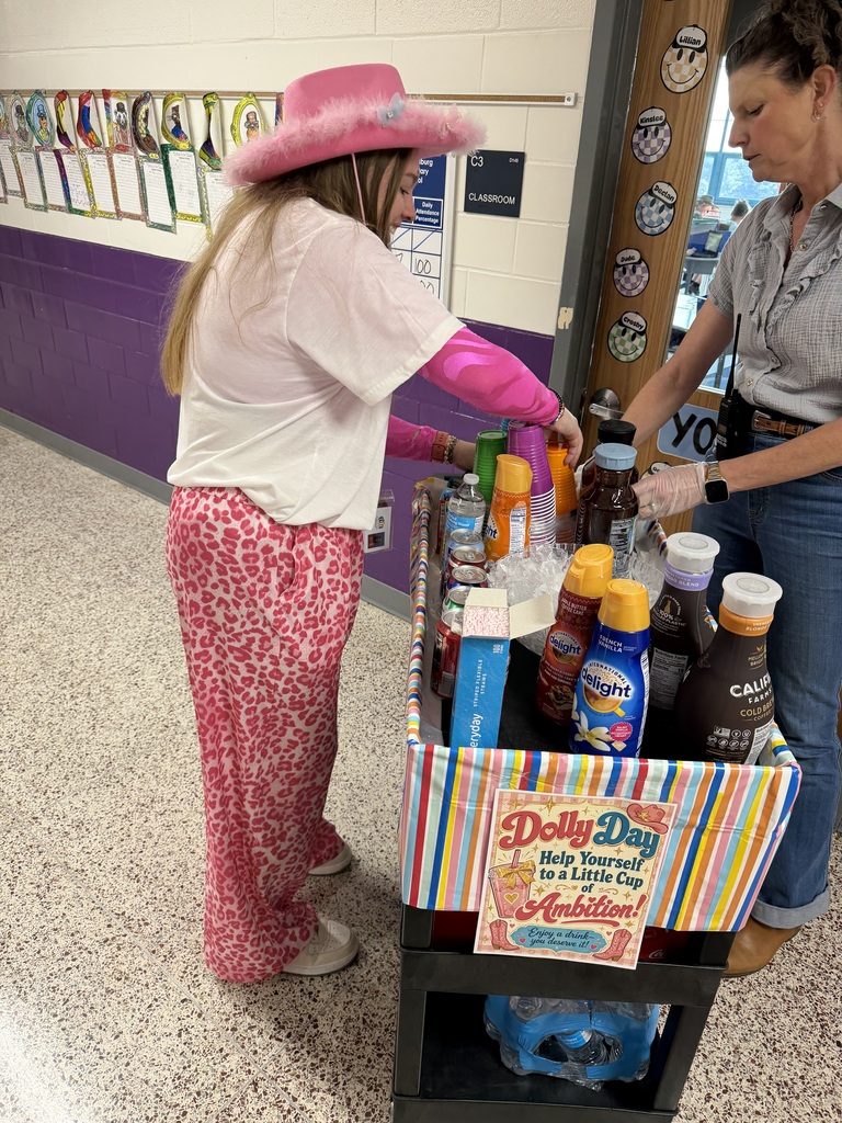 School administrator serving a teacher dressed in pink fun  beverages on a cart.