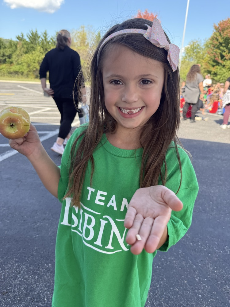 Young child holding an apple.