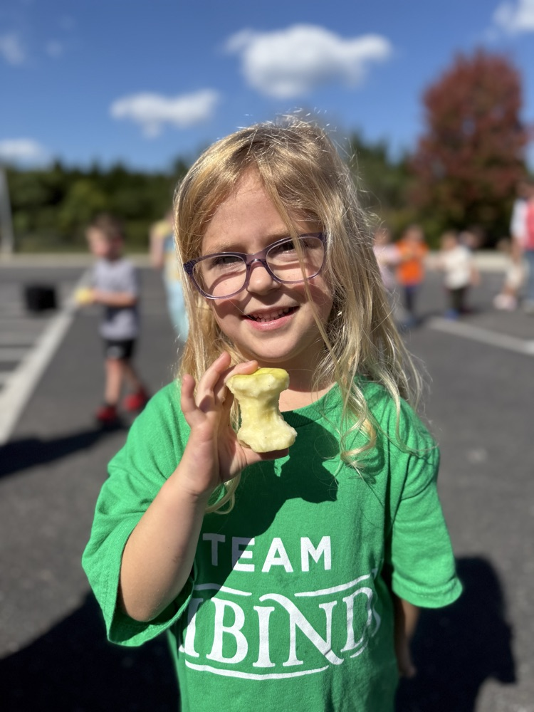 Young child holding an apple.