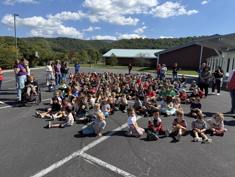 Group of kids outside for an apple tasting event. 
