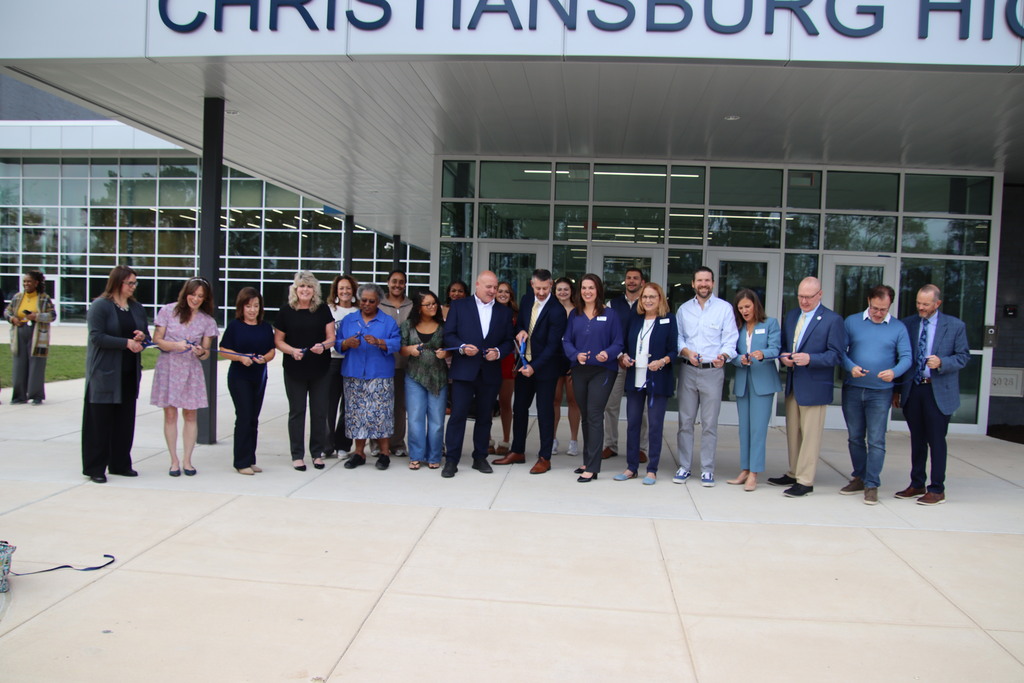 School and community leaders participate in a ribbon-cutting ceremony outside Christiansburg High School's entrance.