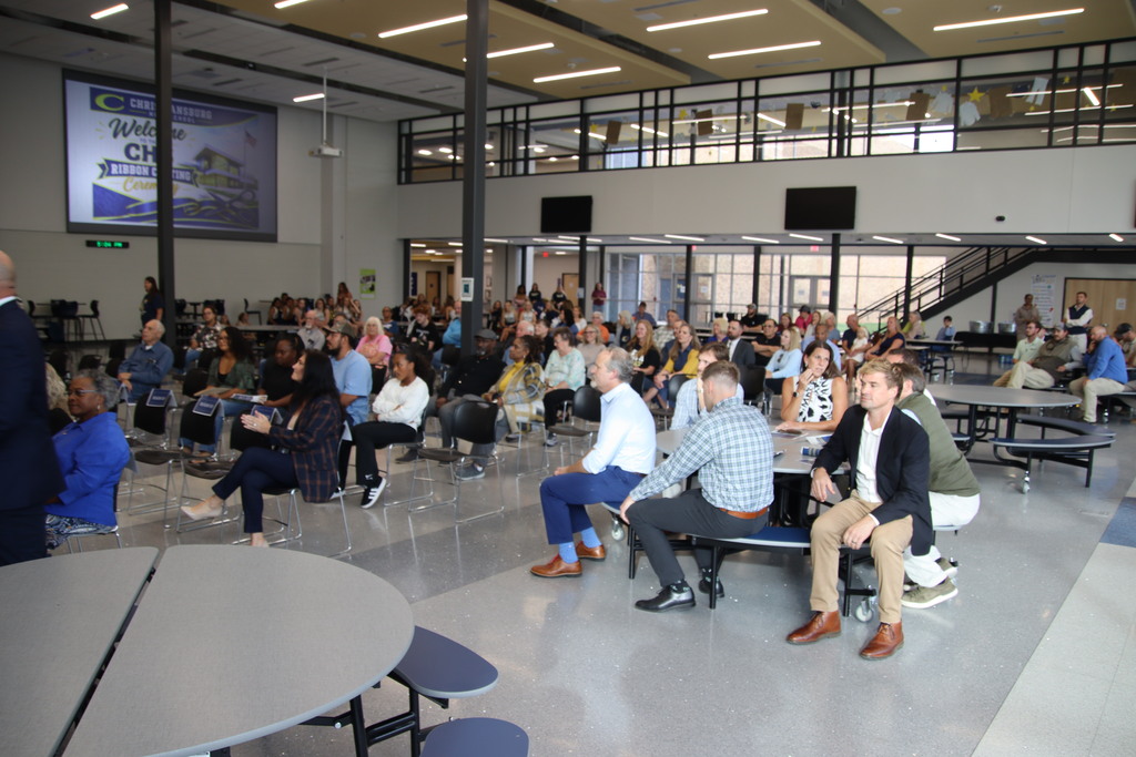 Community members and school officials gather in the cafeteria for Christiansburg High School's ribbon-cutting ceremony.