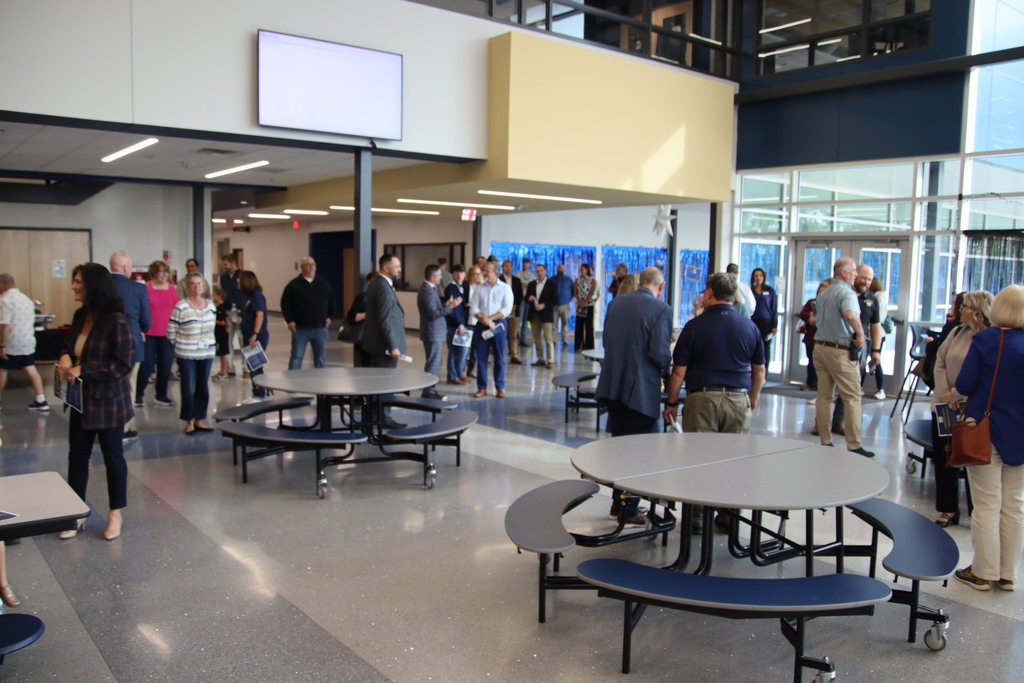 Guests mingle in the spacious, modern Christiansburg High School cafeteria before a ribbon-cutting ceremony.
