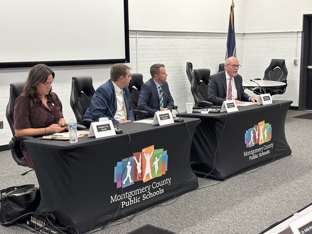 Delegate Lily Franklin, District Director Cody Rush, Senator David Suetterlein, and Congressman Morgan Griffith seated at a table with Montgomery County Public Schools branded table skirts during a panel discussion