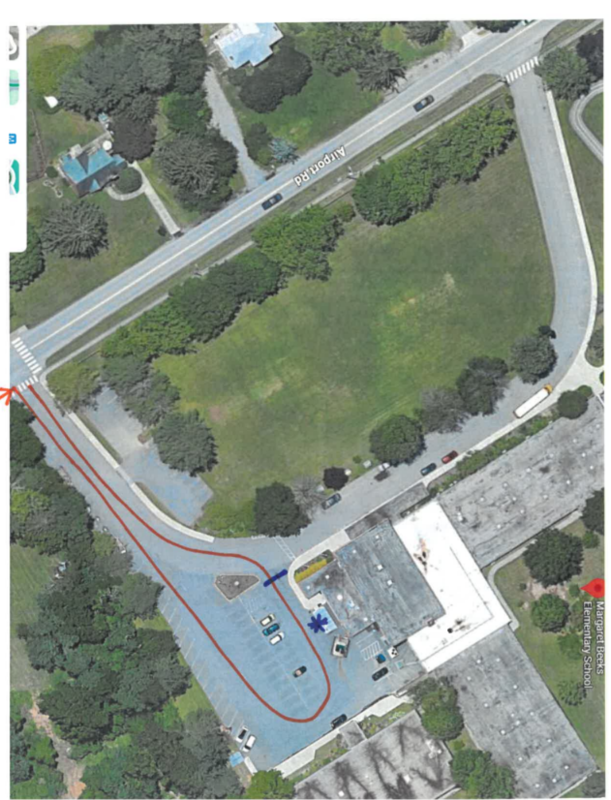 "An aerial satellite map of the Margaret Beeks Elementary School parking lot and driveway off Airport Road. Red lines and arrows outline the specific loop and traffic flow route designated for car rider dismissal."