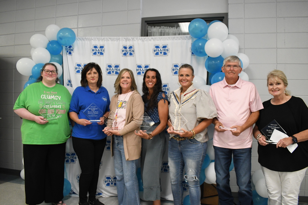 group of people holding awards