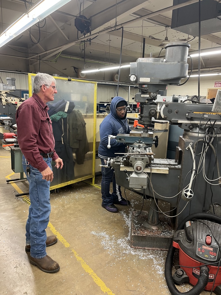 student standing at a machine