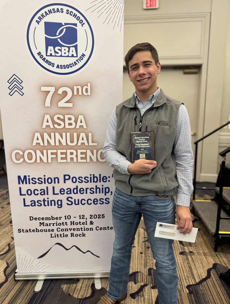 student in front of sign 